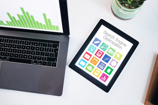 Seo, tablet and laptop screen with data in top view in office, company or workplace. Computer desk, tech and statistics, graphs and chart for analytics, ui or icons for marketing, advertising or app.