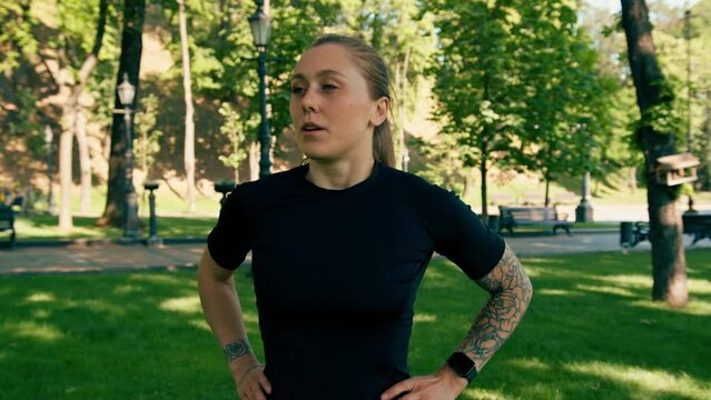 Portrait of a young sportswoman checking the time and pulse on a smart watch after a workout in the park a healthy lifestyle concept