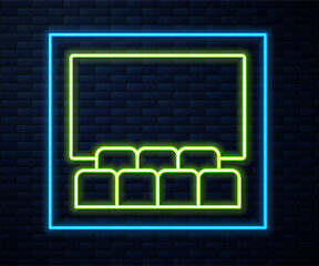 Glowing neon line Cinema auditorium with screen icon isolated on brick wall background. Vector