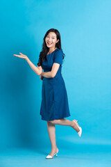 Portrait of beautiful woman in blue dress, isolated on blue background
