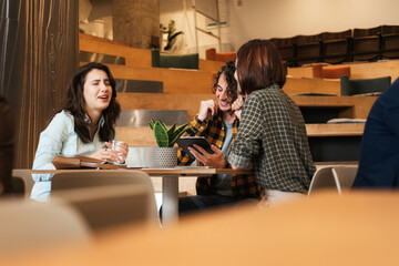 Young college friends talking in the cafeteria