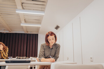 Lovely short haired female student having exam at university