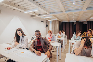 Different aged, multiracial business people solving exam after business training during brainstorming at work