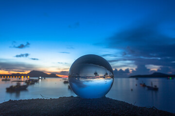 view of the sea and sky inside crystal ball. The natural view of the sea and sky are unconventional and beautiful. .A image for a unique and creative travel idea.