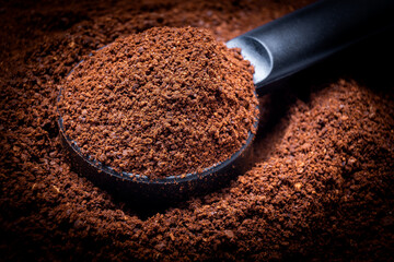 Ground coffee background and coffee spoon