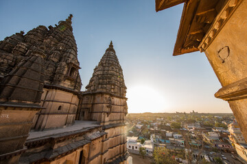 View from a roof top of a temple in idea during sunset with antique tower silhouettes in the foreground