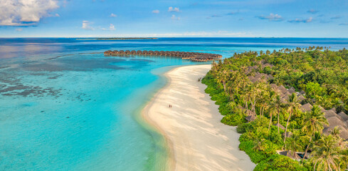 Beautiful amazing Maldives paradise. Fantastic tropical aerial travel landscape, seascape. Luxury water villas bungalows. Dream vacation, best destination aerial drone beach view. Palm trees sea sky