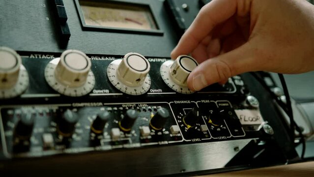 Sound engineer using digital audio mixer sliders Engineer pressing keys adds control panel volume Recording studio technician close up