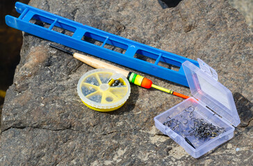 Fishing tackle on a stone near the Dnieper River.