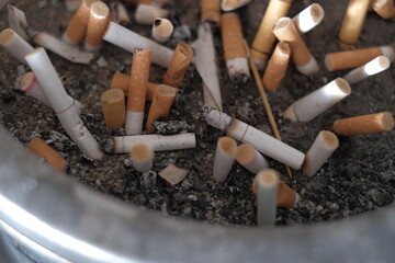 Cigarettes burning in smoking areas