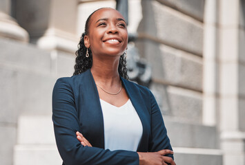 Arms crossed, happy black woman or lawyer thinking with smile or confidence working in a law firm. Court, empowerment or proud African attorney with leadership, ideas or vision for legal agency