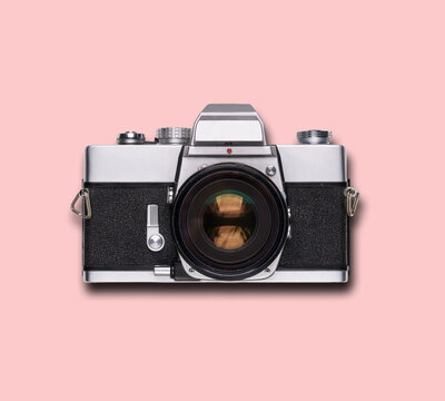 vintage old film camera on pink background