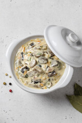 Creamy garlic carrot mushroom pasta sauce in pot. Top view, copy space.