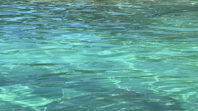 Blue turquoise sea water surface, vertical video.