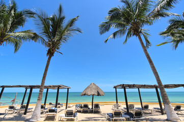 Chairs on a sand beach and horizon (Merida, Yucatan, Mexico)