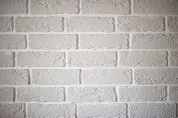 Part of the wall is made of decorative tiles in the form of white bricks.