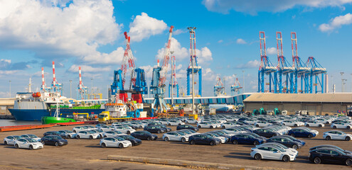 New imported cars and Shipping containers being unloaded at port facilities in Ashdod, Israel,...