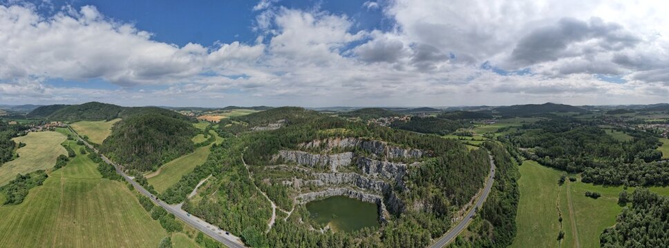 Aerial panorama of Rabi Castle on a hill above the countryside, showing medieval ruins, rolling landscape, and historic Bohemian scenery near Klatovy.