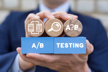 Man holding colorful styrofoam blocks sees inscription: A/B TESTING. AB testing wireframe campaign...