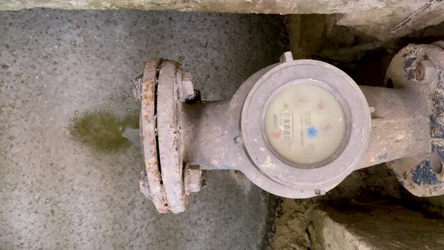 Dirty water coming out from the water meter pipe. Pouring water produce foam. Chemical waste water from industrial process. Wastewater Treatment Procedure (WWTP)