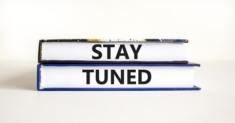 Stay tuned symbol. Concept words Stay tuned on beautiful books on a beautiful white table white background. Business, support, motivation, psychological and stay tuned concept. Copy space.