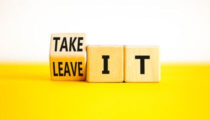 Take or leave it symbol. Businessman turns wooden cubes and changes words Leave it to Take it. Beautiful yellow table white background. Copy space. Business and take or leave it concept.