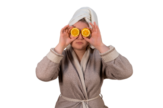 A girl in a bathrobe closes her eyes with lemons on a transparent background. Healthy lifestyle. Cold season concept