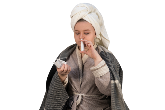A girl with symptoms of a cold on a transparent background injects a spray into her nose. Runny nose and allergies. The concept of medicine, pharmacy, healthcare and home treatment