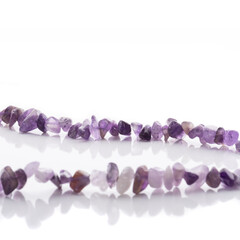 Strung amethyst natural stone strings on white background. Energy crystals. Healing gemstones....