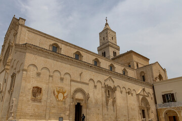Obraz premium View of the city of Matera by day. Typical Salento illuminations during the holidays. Feast of the Brown Madonna, Matera. Prehistoric caves from the Murgia.Mysterious and ancient land among the stones