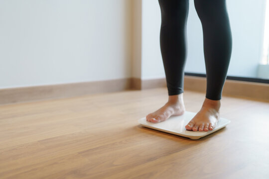 Lose Weight. Fat Diet And Scale Feet Standing On Electronic Scales For Weight Control. Measurement Instrument In Kilogram For Diet.