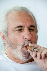 hispanic old man smoking cuban cigar. Hispanic senior man enjoying a Cuban cigar. old Hispanic man...