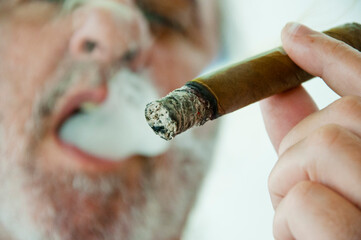 Cuban cigar closeup. smoking hispanic old man. retirement lifestyle. hispanic old man smoking cuban...