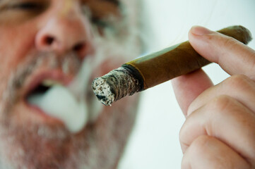 smoking hispanic old man. retirement lifestyle. hispanic old man smoking cuban cigar. Hispanic...