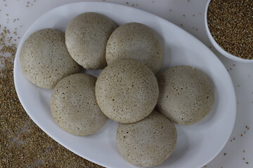 Bajra idly. Steamed savory rice cake made by a batter of fermented de husked black lentils and unpolished pearl millet