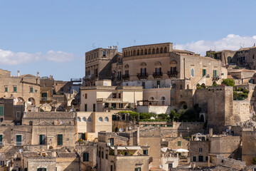 Obraz premium View of the city of Matera by day. Typical Salento illuminations during the holidays. Feast of the Brown Madonna, Matera. Prehistoric caves from the Murgia.Mysterious and ancient land among the stones