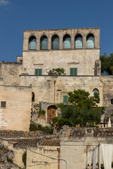 Fototapeta premium View of the city of Matera by day. Typical Salento illuminations during the holidays. Feast of the Brown Madonna, Matera. Prehistoric caves from the Murgia.Mysterious and ancient land among the stones