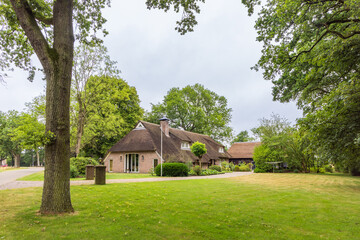 Fototapeta na wymiar Traditional farmhouse with thatched roof in Odoorn in Drenthe The Netherlands