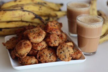 Bite sized plantain fritters. Ripe plantain disk dipped in a batter of whole wheat flour and sesame seeds and deep fried