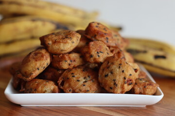 Bite sized plantain fritters. Ripe plantain disk dipped in a batter of whole wheat flour and sesame seeds and deep fried