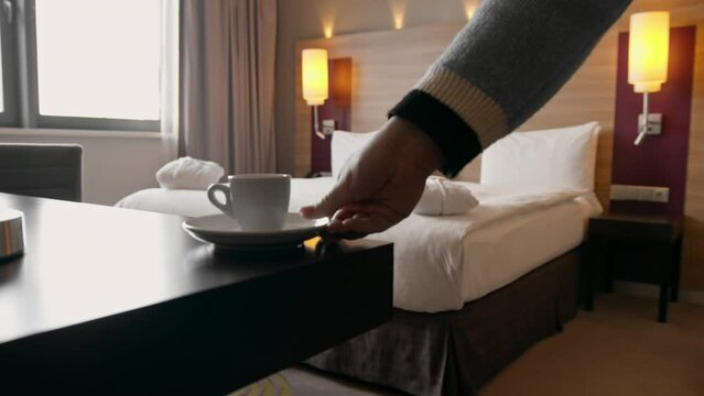the interior of a double hotel room, a rest room a housekeeping worker puts cups in the room the concept of cleanliness and hospitality travel rest