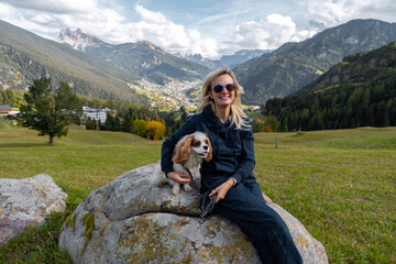 woman with a dog in mountains 