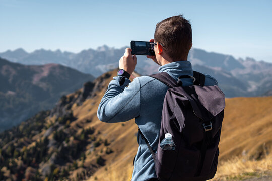 person taking pictures in mountains 