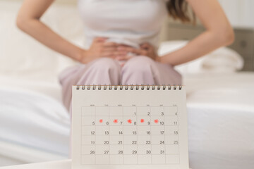 Menstruation, period cycle day of monthly, hurt asian young woman, female hand in stomachache, suffer from PMS premenstrual, belly or abdomen pain on bed at home. Health problem Inflammation in body - obrazy, fototapety, plakaty