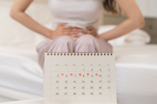 Menstruation, period cycle day of monthly, hurt asian young woman, female hand in stomachache, suffer from PMS premenstrual, belly or abdomen pain on bed at home. Health problem Inflammation in body