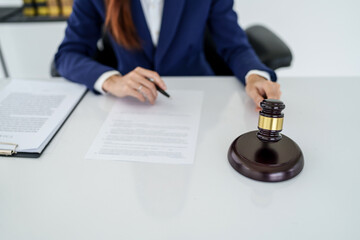 Lawyer preparing to sign a contract and wooden gavel on table justice and law concept