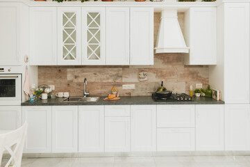 Fototapeta na wymiar interior of modern white wooden kitchen in neoclassical style