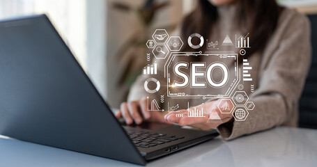 Search Engine Optimization (SEO). Woman using computer to analyze data statistics reports to...