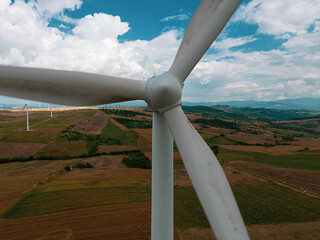 aerial view of a wind farm in Campania. The wind turbines are immersed in cultivated agricultural fields
