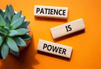 Patience is Power symbol. Concept words Patience is Power on wooden blocks. Beautiful orange background. Business and Patience is Power concept. Copy space.